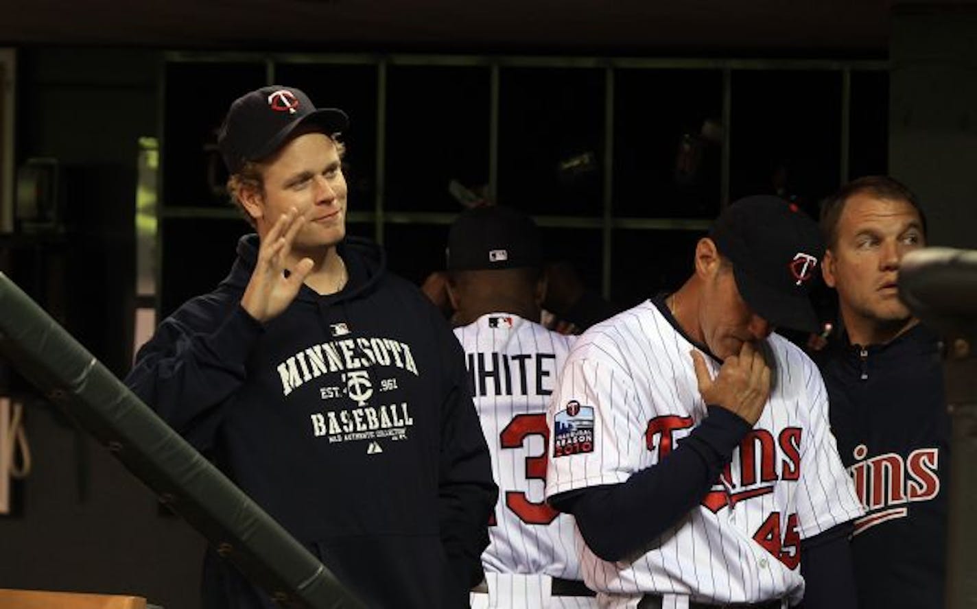 Twins' Justin Morneau waved from the dugout late in the game.