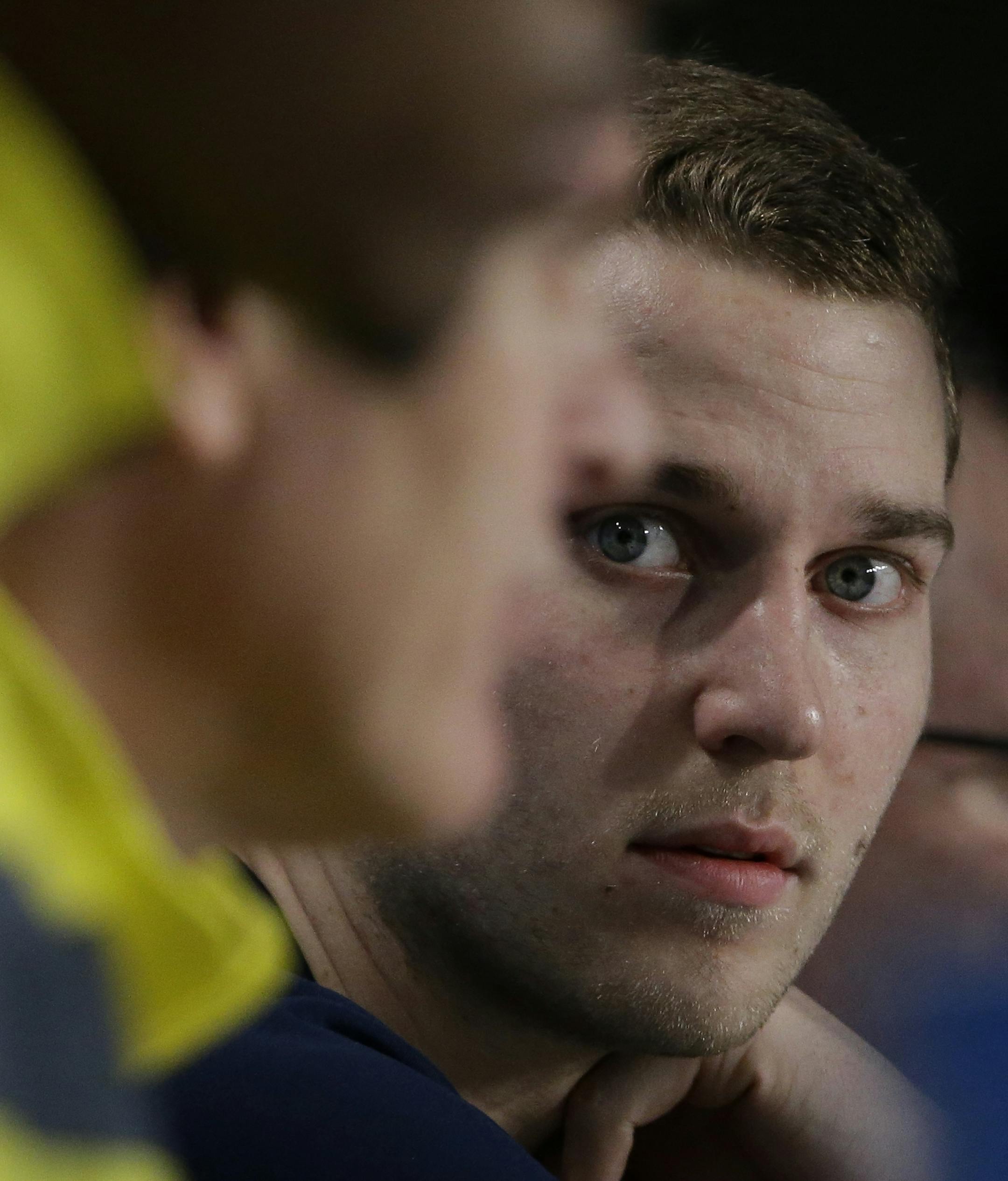 Michigan's Nik Stauskas, right, listens as head coach John Beilein answers questions during an interview session for the NCAA Midwest Regional final college basketball tournament game Saturday, March 29, 2014, in Indianapolis. Michigan plays Kentucky in the final on Sunday, March 30, 2014. (AP Photo/David J. Phillip)