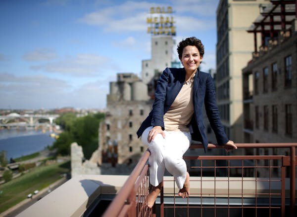 Realtor Cynthia Froid, seen atop the North Star Woolen Mill building, has carved out a niche as a Mill District condo matchmaker.