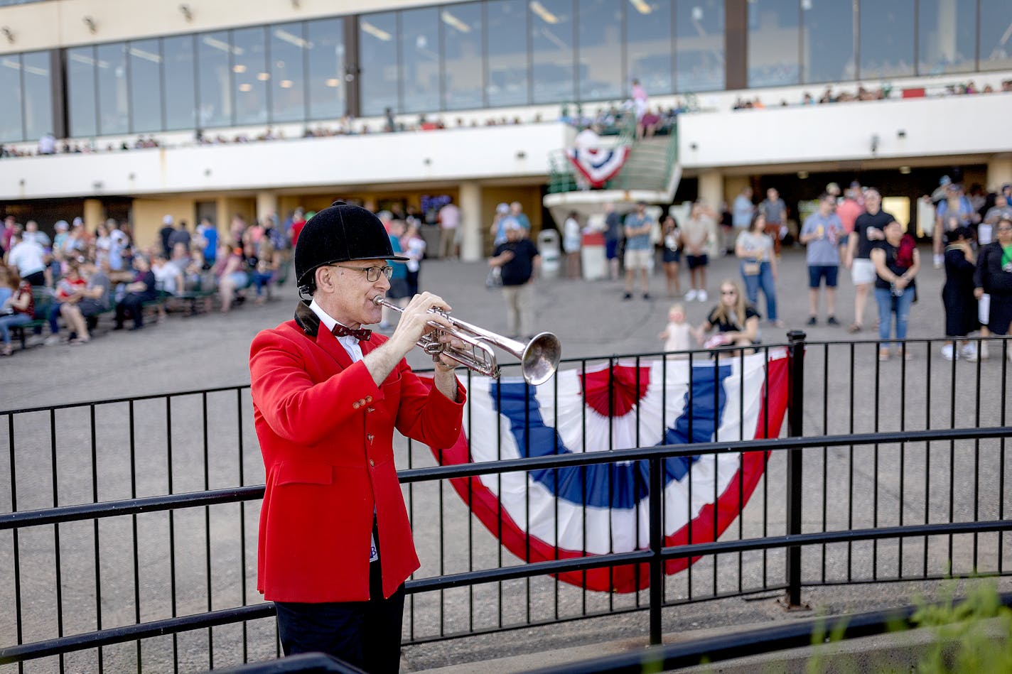 Bugler Lynn Deichert waits for his cue to go on during a race on opening night at Canterbury Park in Shakopee, Minn., on Saturday, May 27, 2023. ] Elizabeth Flores • liz.flores@startribune.com