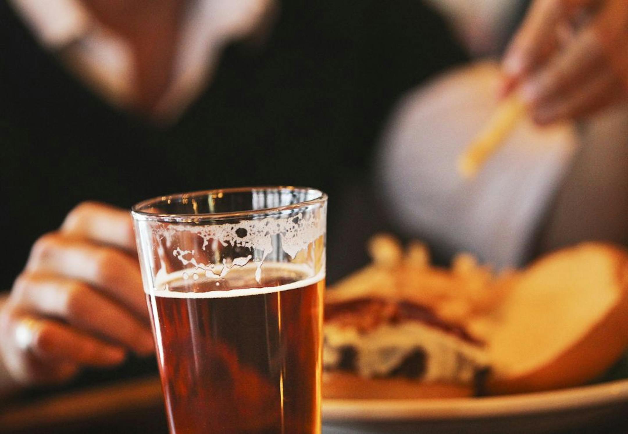 Ryan Rahinel enjoyed frieds and a burger with a beer with Noelle Nelson, not pictured, over lunch at Town Hall Brewery Wednesday, March 7, 2012, in Minneapolis, MN. Rahinel enjoyed a 342 and Nelson a Twisted Jim - both specialty beers brewed at Town Hall.