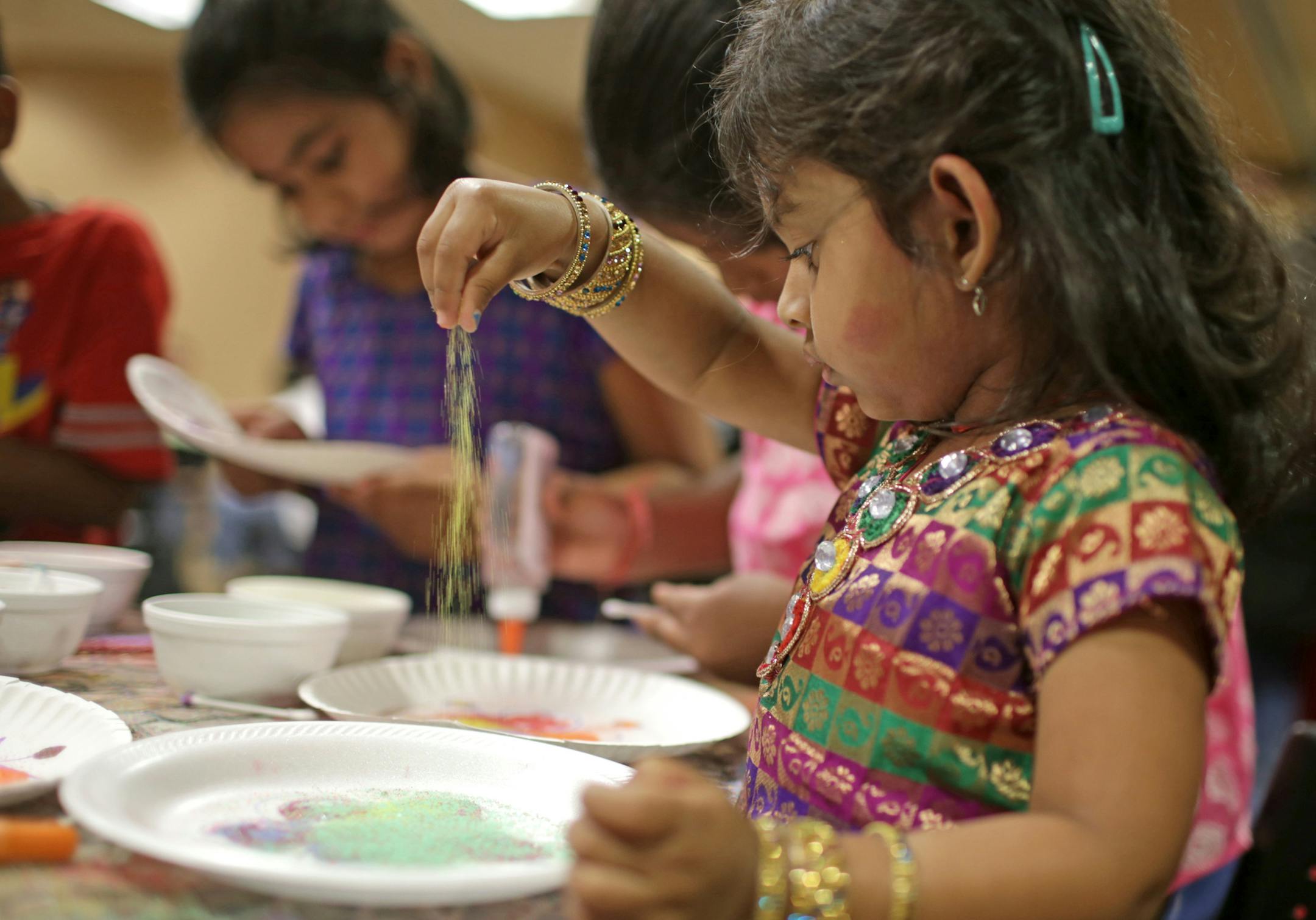Srishti, 3 1/2, does Rangoli Sunday afternoon. Sunday was "Cultural Heritage Day" at the Hindu Temple of Minnesota in Maple Grove. Activities included dance and musical performances, henna decorations, Rongoli (sacred ancient symbols to welcome Hindu deities), plenty of food and student projects. Folks could also visit the temple. ] David Denney ddenney@startribune.com STAR TRIBUNE 080314 Maple Grove , MN SAXO 127581