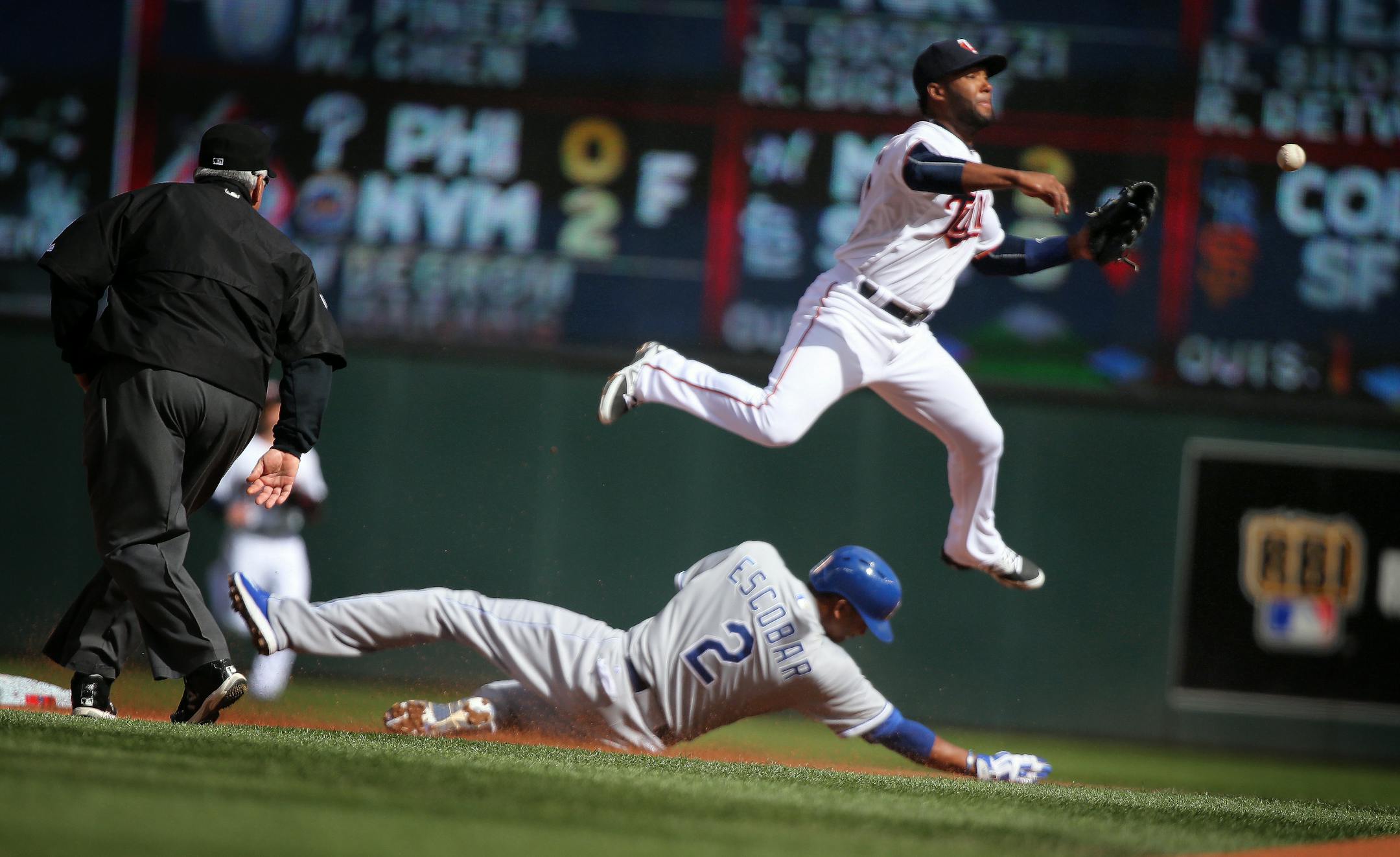 Danny Santana fails to make a double play from second base as Alcides Escobar of the Royals slides in safe during a game last season.