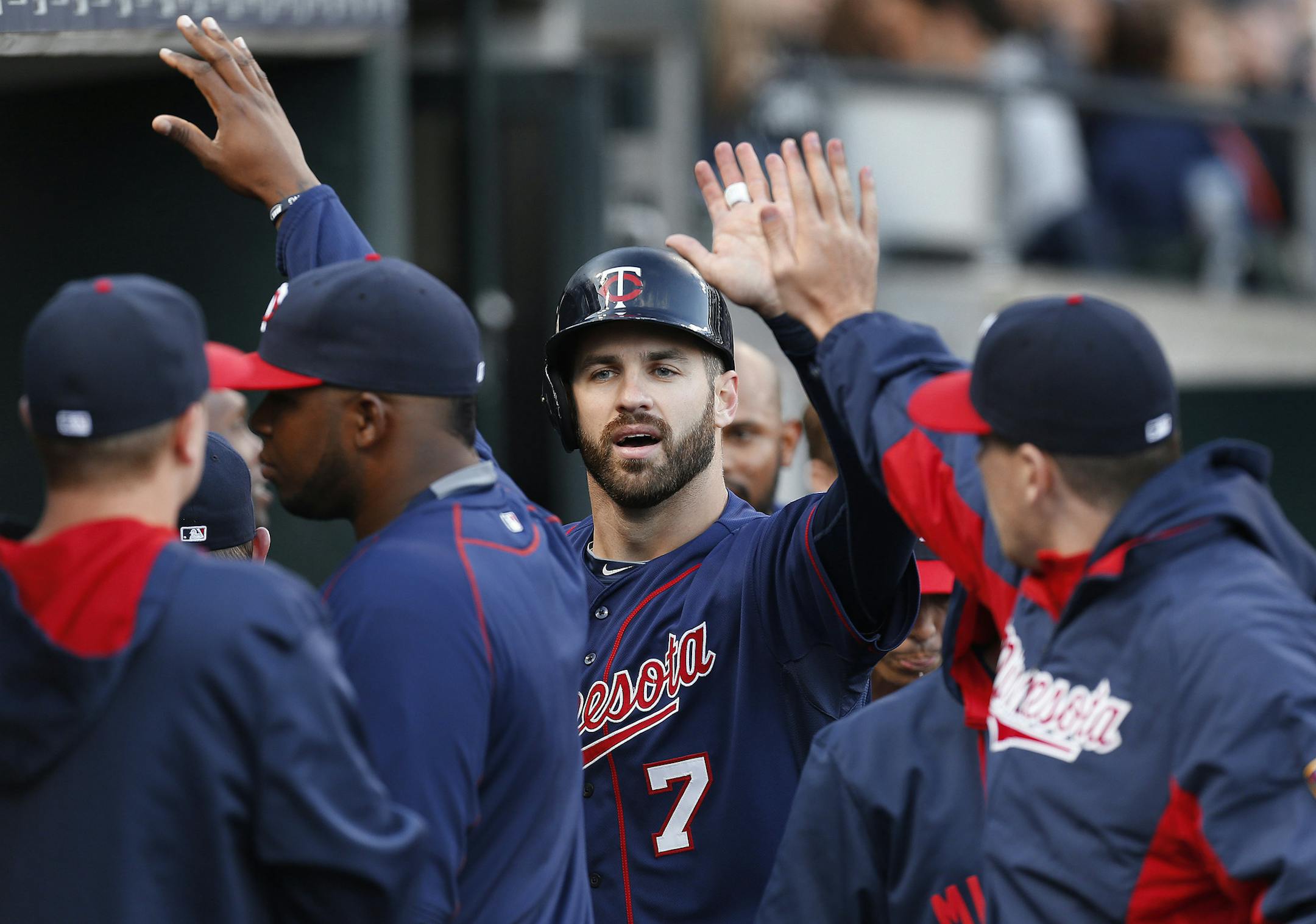 Minnesota Twins' Joe Mauer (7) celebrates scoring on a Trevor Plouffe triple in the third inning of a baseball game against the Detroit Tigers on Wednesday, May 13, 2015, in Detroit. (AP Photo/Paul Sancya)