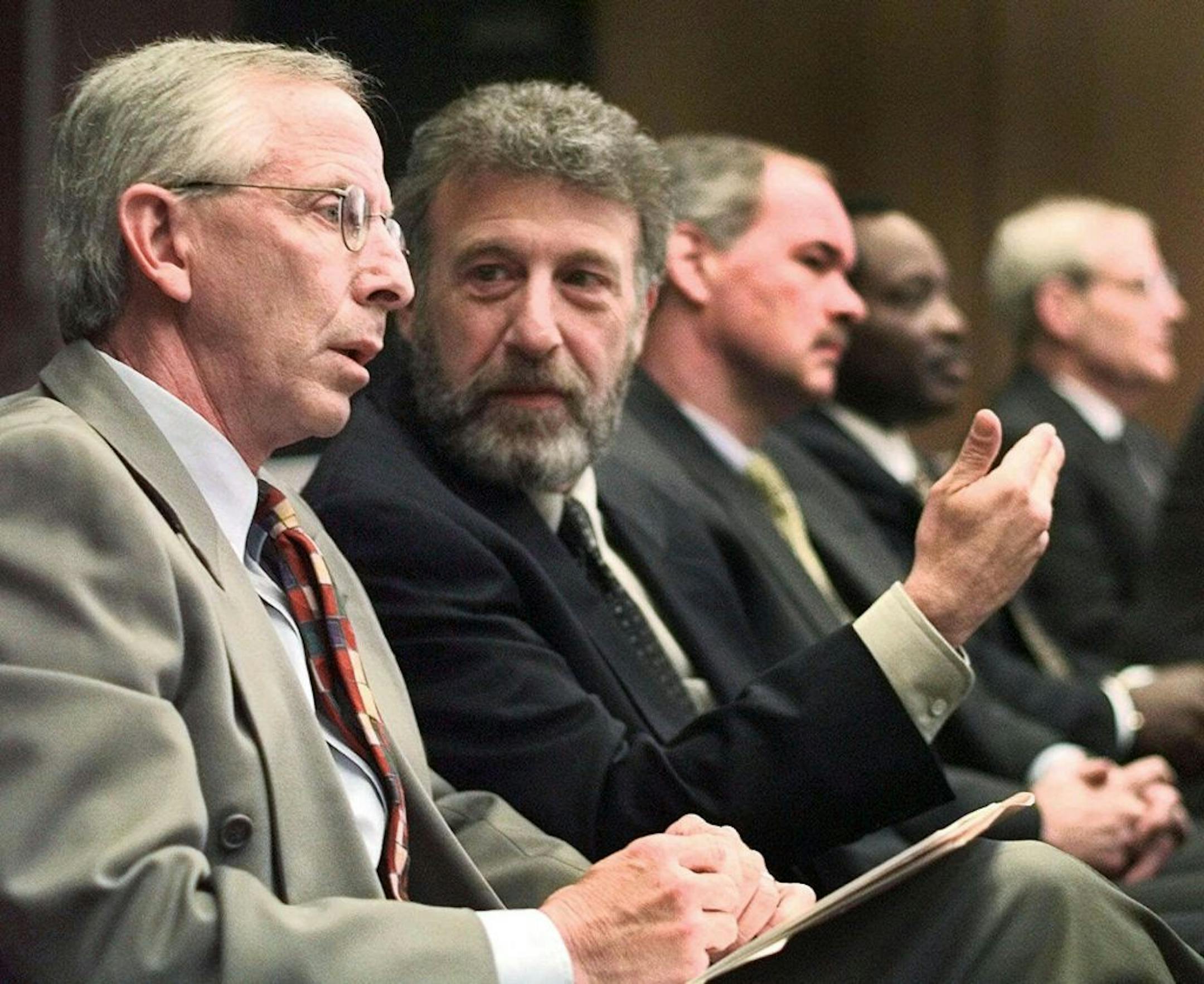 FILE - In this Thursday, May 6, 1999 file photo, George Zimmer, second from left, gestures in a meeting in Oakland, Calif. Men's Wearhouse Inc. says it has dismissed Zimmer, its founder and executive chairman.