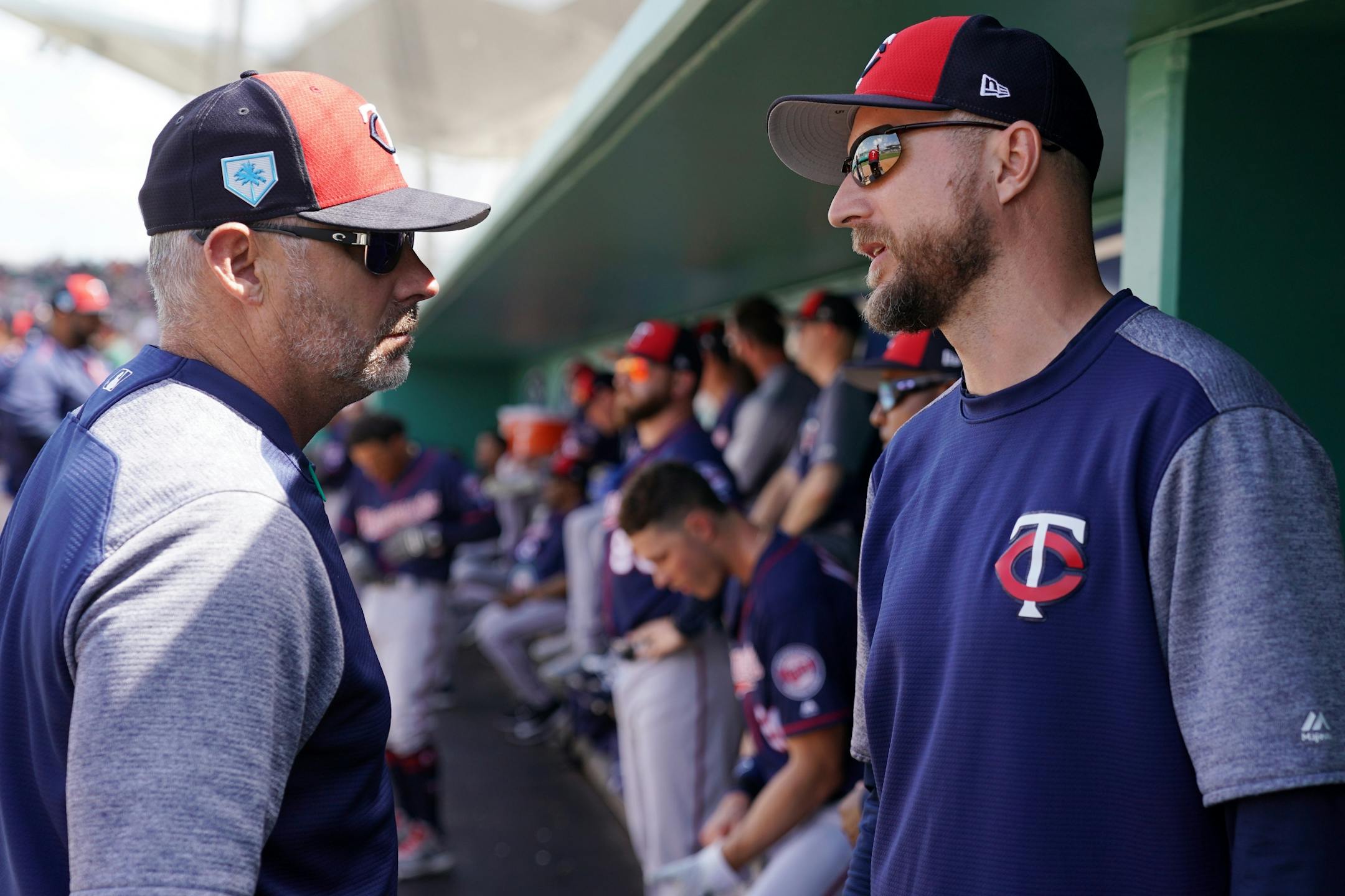 Minnesota Twins manager Rocco Baldelli (5) talked with bench coach Derek Shelton (9) in the dugout before Sunday's game.