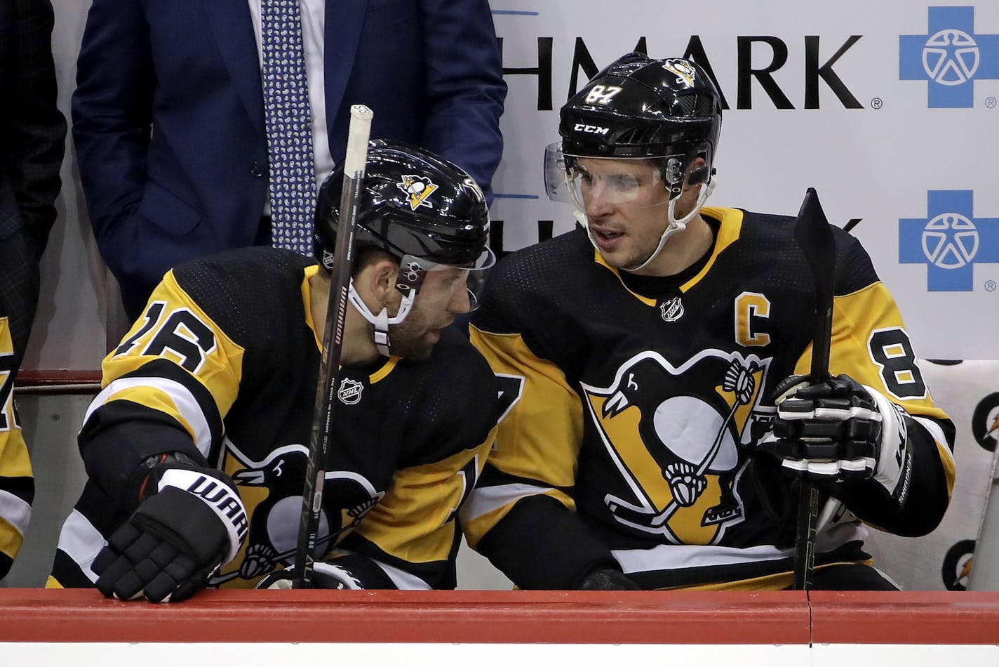 Pittsburgh Penguins' Sidney Crosby (87) talks with Jason Zucker (16) during the first period of an NHL hockey game against the Tampa Bay Lightning in Pittsburgh, Tuesday, Feb. 11, 2020. (AP Photo/Gene J. Puskar)