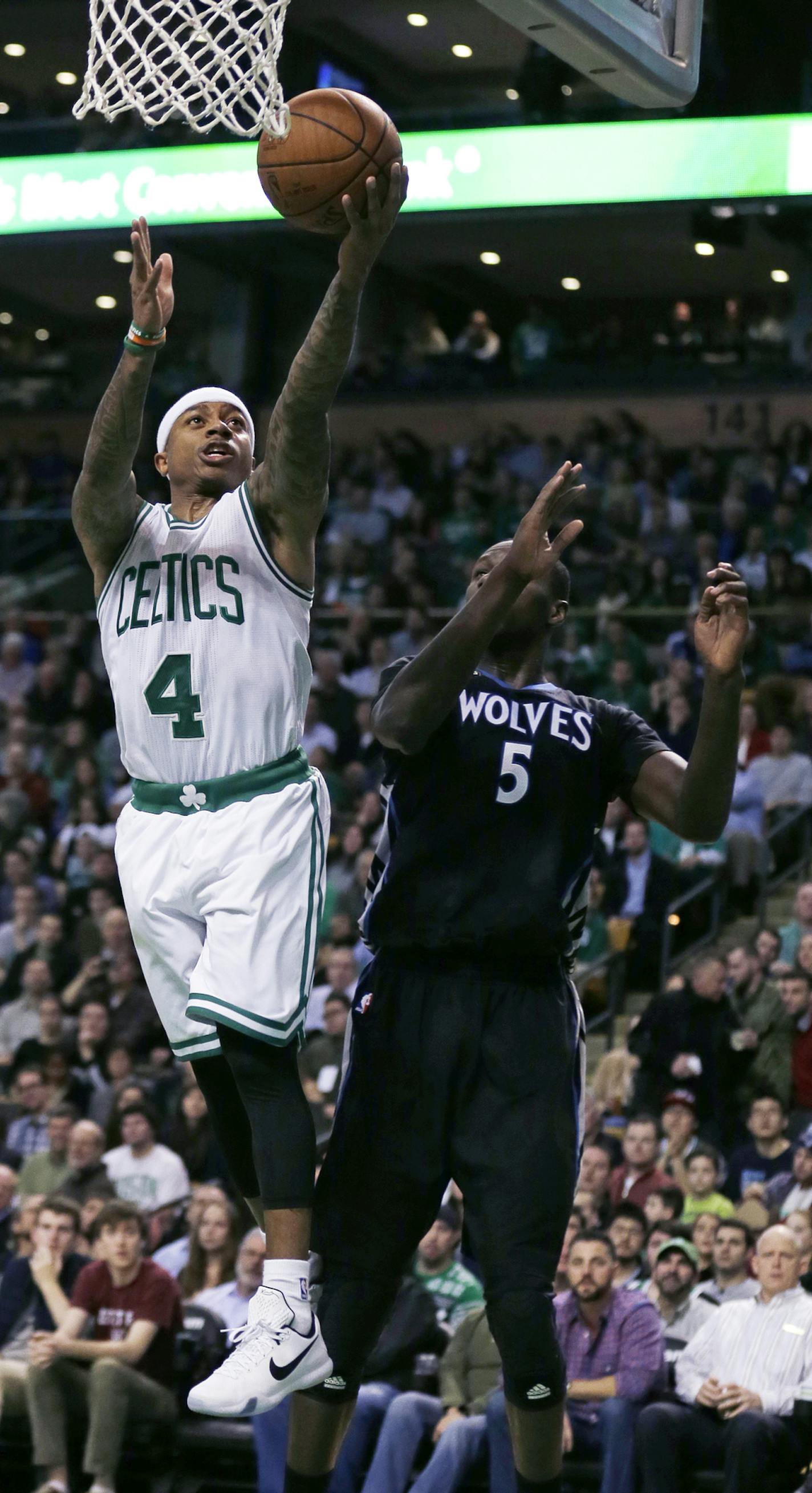 Boston Celtics guard Isaiah Thomas (4) drives to the basket past Minnesota Timberwolves center Gorgui Dieng (5) during the first quarter of an NBA basketball game in Boston, Monday, Dec. 21, 2015. (AP Photo/Charles Krupa)