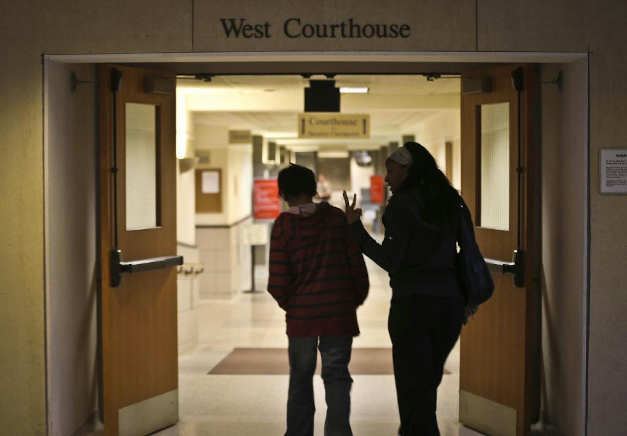 Shameka Griffin walked with her son Gianni Griffin-Davis into the Anoka County Courthouse for a hearing on Gianni's competence in a sexual misconduct case on Thursday, June 6, 2013 in Anoka, Minn.