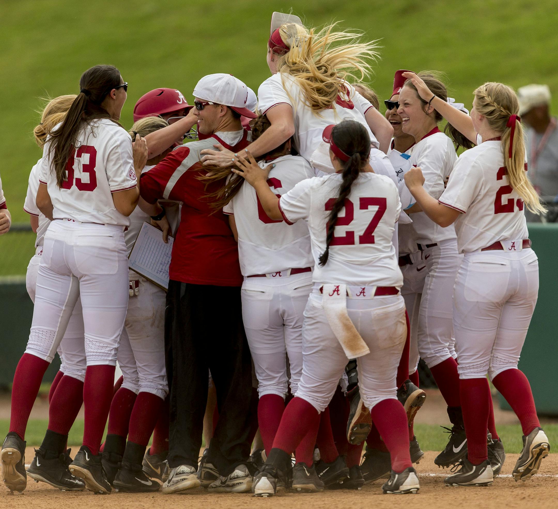 Alabama's Reagan Dykes is mobbed by teammates after her game winning bases-loaded walk against Minnesota in the NCAA regional softball tournament, Saturday, May 20, 2017, at Rhoads Stadium in Tuscaloosa, Ala. Alabama won 1-0. (Vasha Hunt/AL.com via AP)