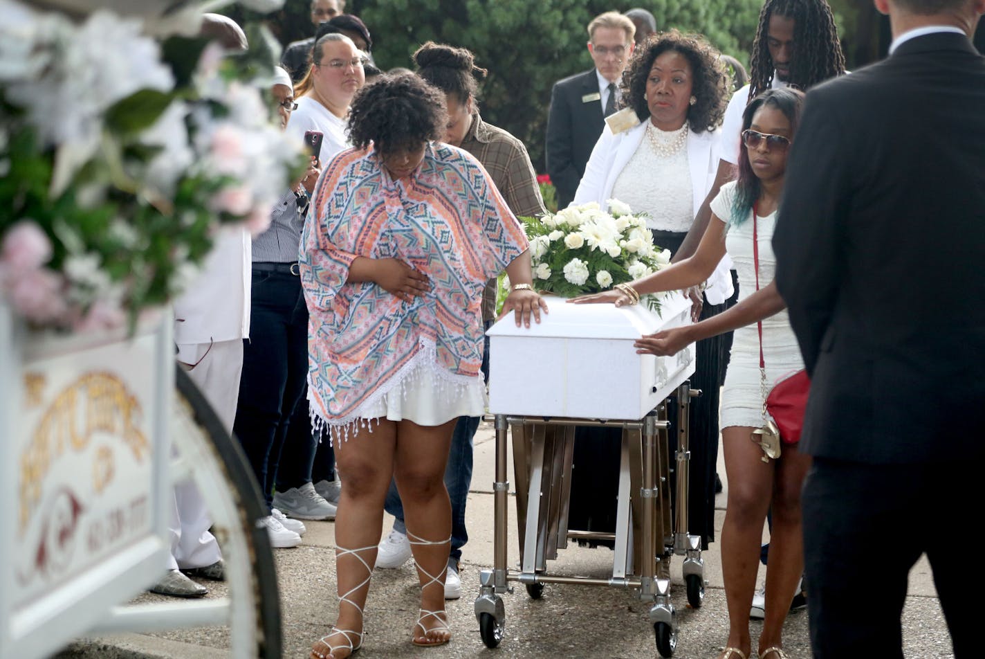 Pallbearers walk with the casket of Le'Vonte King Jason Jones, 2, shot and killed in a drive-by shooting, to a horse drawn hearse following a celebration of life service July 15, 2016, at Bethel Christian Fellowship.