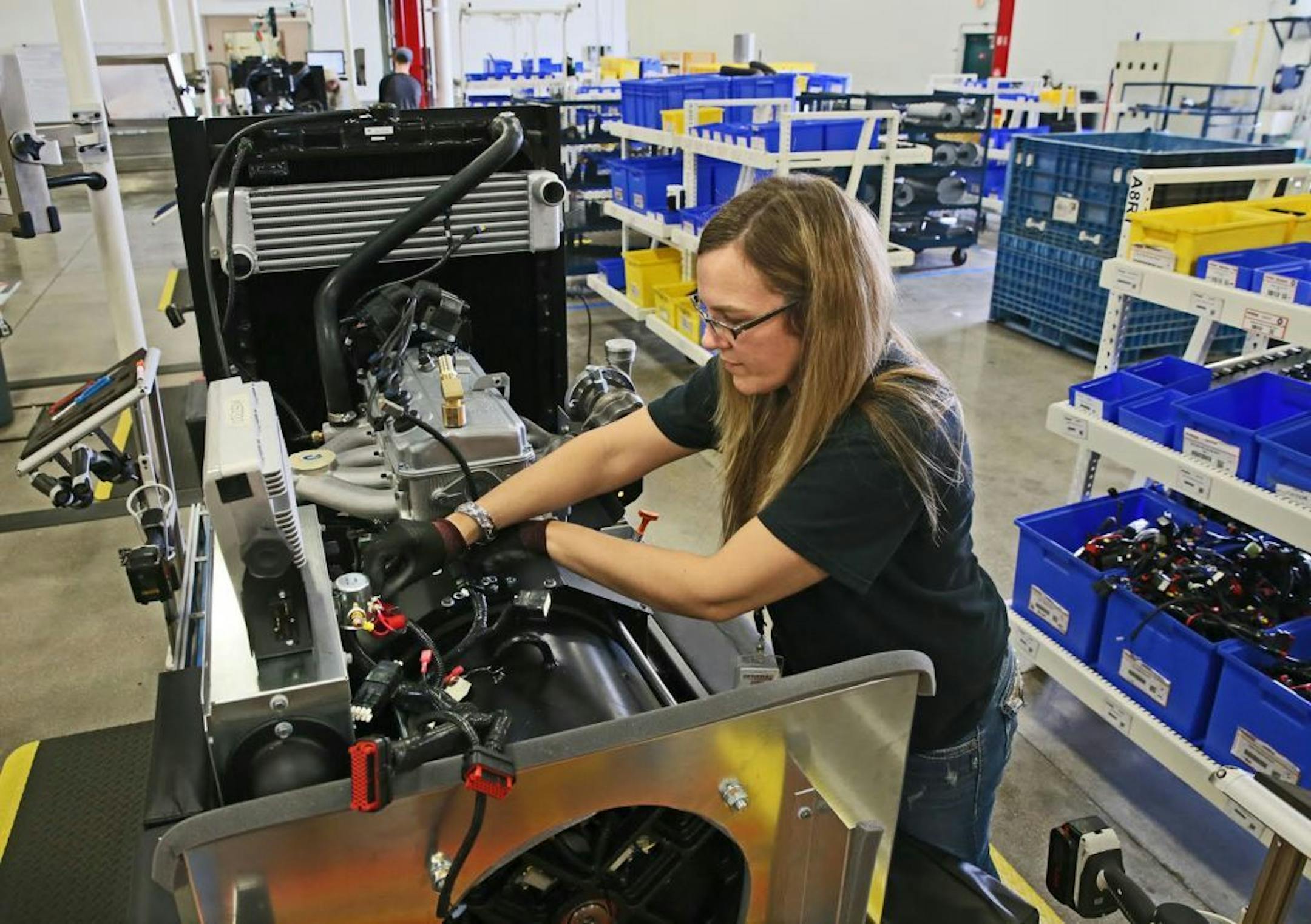 Kristy Westenberg works at Generac in Whitewater, Wisc., where she installs wiring harnesses on generators on Oct. 16, 2014.