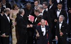 Fred Berger, producer of "La La Land," foreground center, gives his acceptance speech as members of PricewaterhouseCoopers, Brian Cullinan, holding re