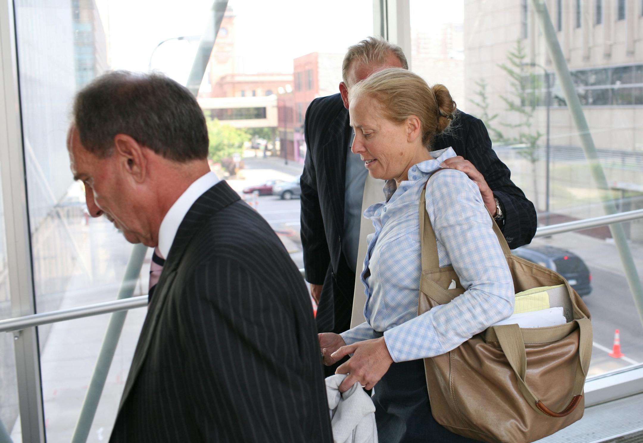 David Marion, the sole owner of a Minneapolis coin firm that was raking in $24 million a year from mostly elderly telemarketing clients who were seeking a safe harbor for their money in the collapsing economy was sentenced Thursday to five years for money laundering and conspiracy in Federal Court. IN THIS PHOTO: David Marion, CENTER not visible behind woman, leaves the Federal Building in Minneapolis Thursday after receiving the 5 year sentence. AT LEFT is his attorney, Craig Cascarano. Woman i