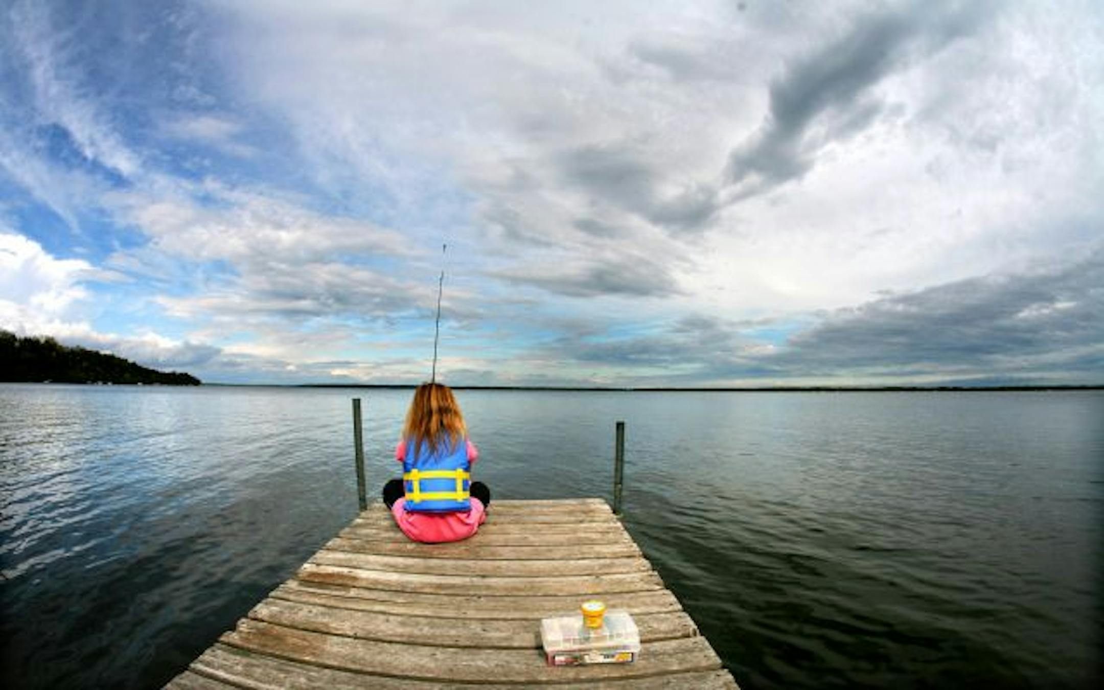 8-year-old Makinzie Wulf (cq) of Burnsville was enjoying the relative quiet on Gull Lake Friday afternoon while fishing at the Quarterdeck Resort with her mother Jennifer Kaiser and boyfriend Mike Dorasio. Wulf was excited to catch a fish with the fishing pole given to her by her grandfather. The family booked the cabin at the last minute and were able to get a beautiful spot on Gull Lake.