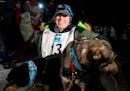 Erin Letzring celebrated with her lead dogs after she won the John Beargrease sled dog marathon by what organizers said was the smallest margins in hi