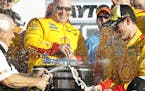 Joey Logano, right, celebrates with team owner Roger Penske, left, after winning the Daytona 500 NASCAR Sprint Cup series auto race at Daytona Interna
