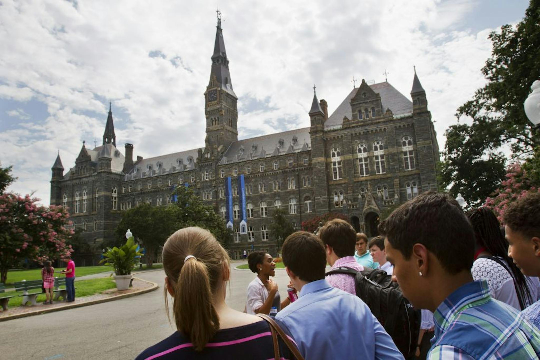 FILE - In this July 10, 2013, file photo, prospective students tour Georgetown University's campus in Washington. The good news is that Americans are saving more than ever for college. The bad news is that the average amount still isn�t enough to cover one year at a four-year public university. In a report released Tuesday. Sept. 9, 2014, the College Savings Plans Network found that the average college savings or prepaid tuition account is now worth about $20,671 _ almost double what these �529�