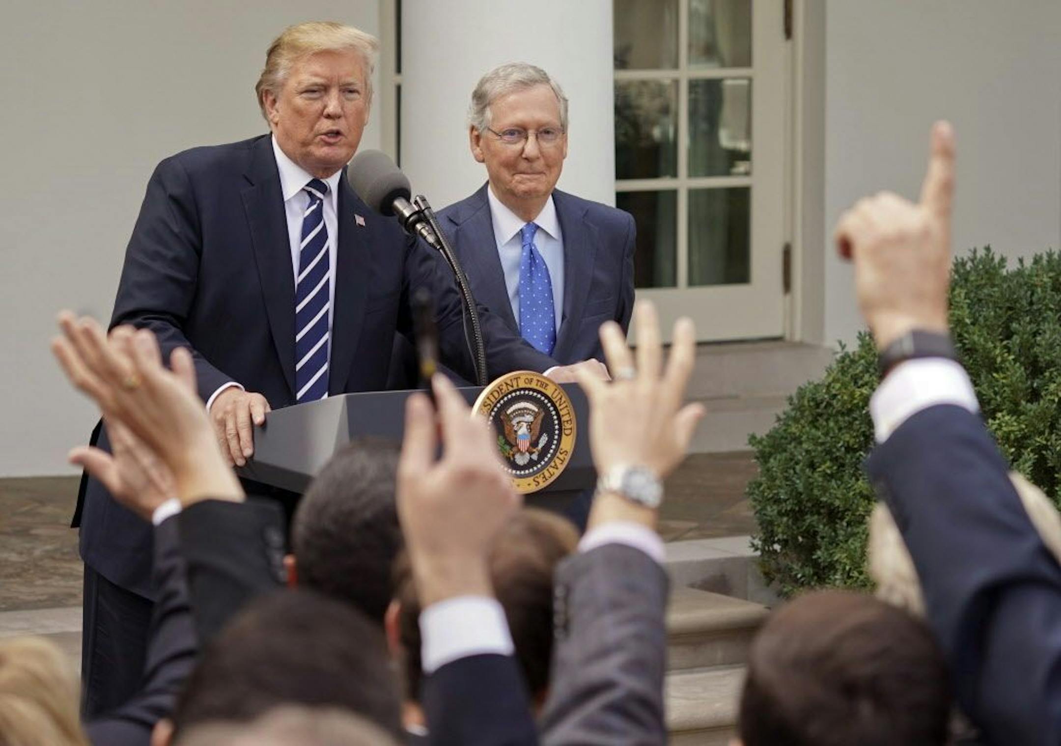 Journalist raise their hands as they wait to called on to ask a question to President Donald Trump and Senate Majority Leader Mitch McConnell of Ky., in the Rose Garden of the White House, Monday, Oct. 16, 2017.