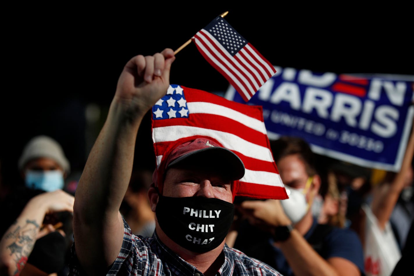 People celebrate outside the Pennsylvania Convention Center, Saturday, Nov. 7, 2020, in Philadelphia, after Democrat Joe Biden defeated President Donald Trump to become 46th president of the United States. (AP Photo/Rebecca Blackwell)