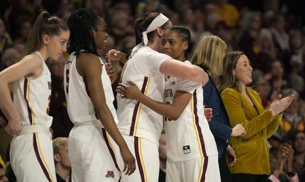 Minnesota Golden Gophers guard Kenisha Bell (23) was hugged by Annalese Lamke (41) as they celebrated a victory over Michigan State earlier this month