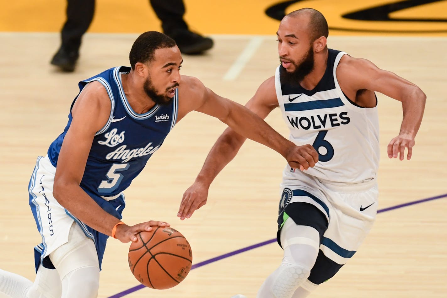 Lakers guard Talen Horton-Tucker, left, drives towards the basket as Timberwolves guard Jordan McLaughlin defends on Dec. 27.