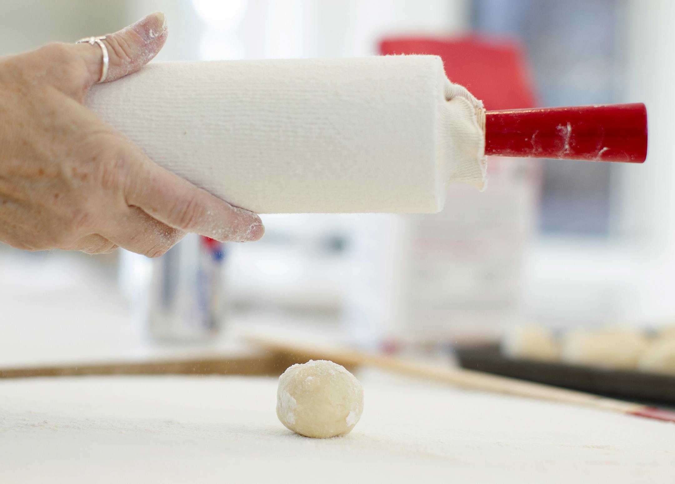 A cloth sleeve coated with flour covers the rolling pin used to mash lefse dough balls into wide, thin circles. The women of the Circle of Gratitude group from Minneapolis' Central Lutheran Church gathered to make lefse at the home of Rebecca Jorgenson Sundquist in Deephaven December 6, 2013. (Courtney Perry/Special to the Star Tribune)