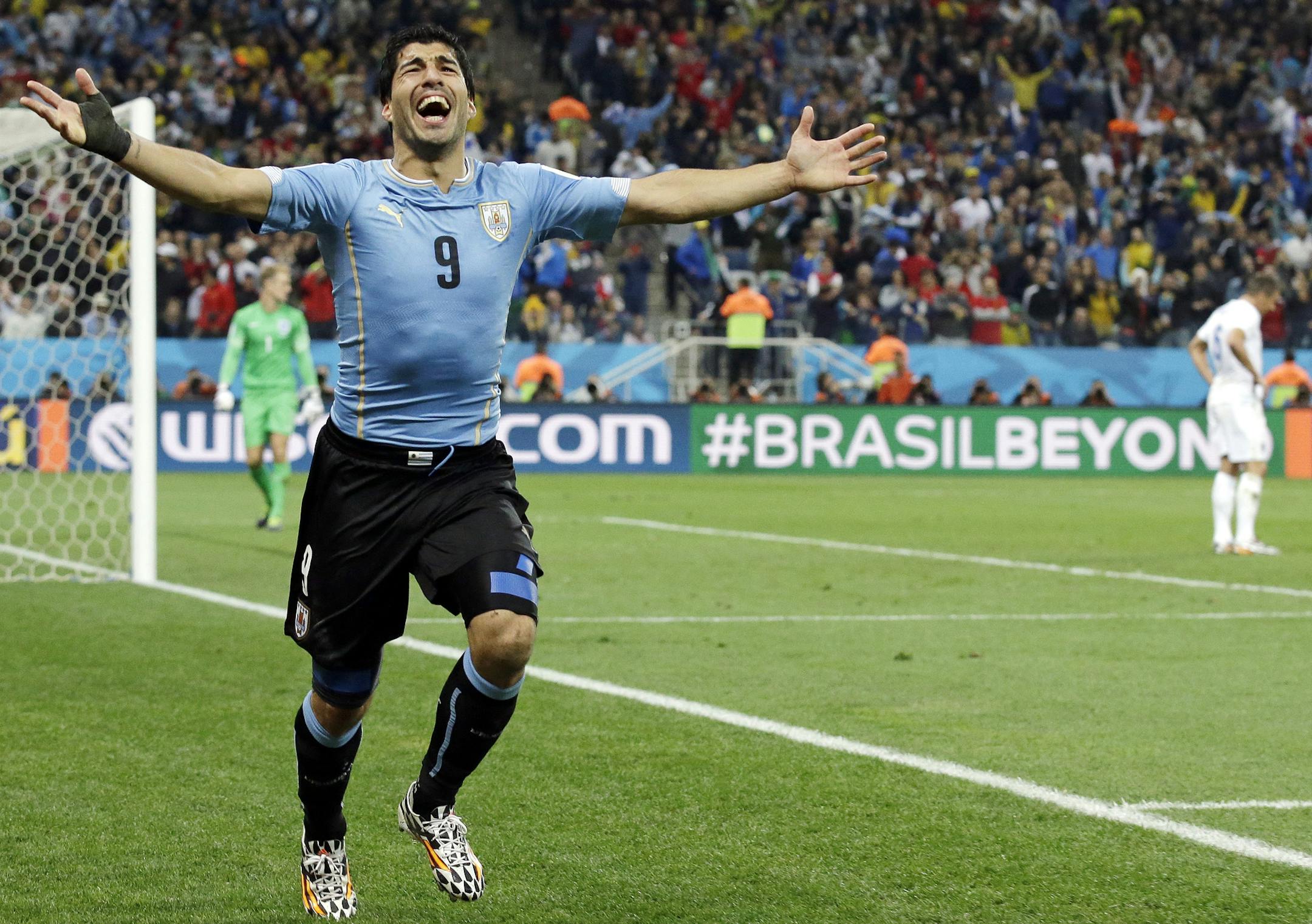 Uruguay's Luis Suarez celebrates after scoring his side's second goal during the group D World Cup soccer match between Uruguay and England at the Itaquerao Stadium in Sao Paulo, Brazil, Thursday, June 19, 2014. (AP Photo/Matt Dunham)