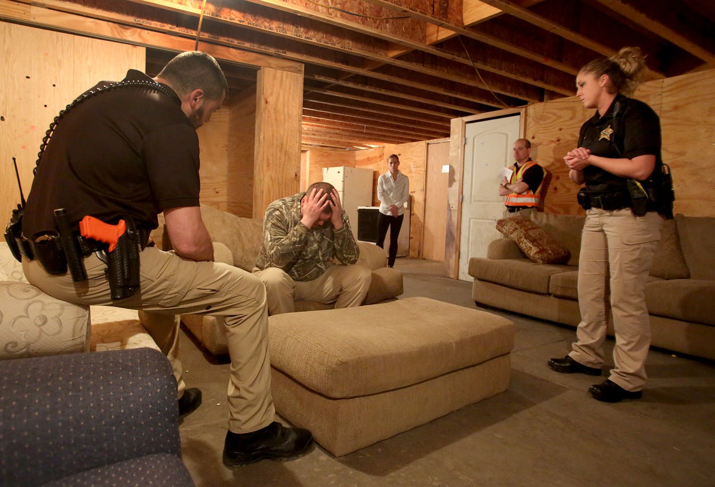 New Dakota County corrections deputies went through training all day at the Flint Hills Training Site Wednesday, March 6, 2018, in Rosemout, MN. Here, Dakota County Dakota County Sheriff's Department Deputy trainers work on de-escalation of a crisis through talking. In this training scenario the husband, Mr. Smith, who has PTSD as the result of military service in Iraq is calmed through talk. Participating in the training were Erik Langgaard, left, and Krystal Johnson, Dakota County Sheriff's De