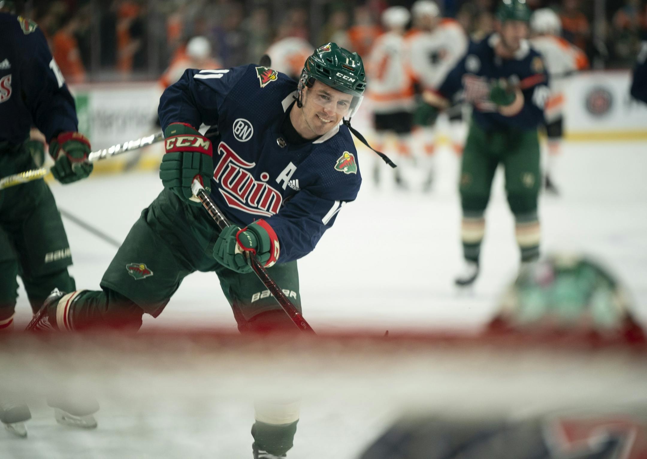 Minnesota Wild left wing Zach Parise (11) and the rest of the team wore Joe Mauer tribute sweaters during their pregame warmups Tuesday night.