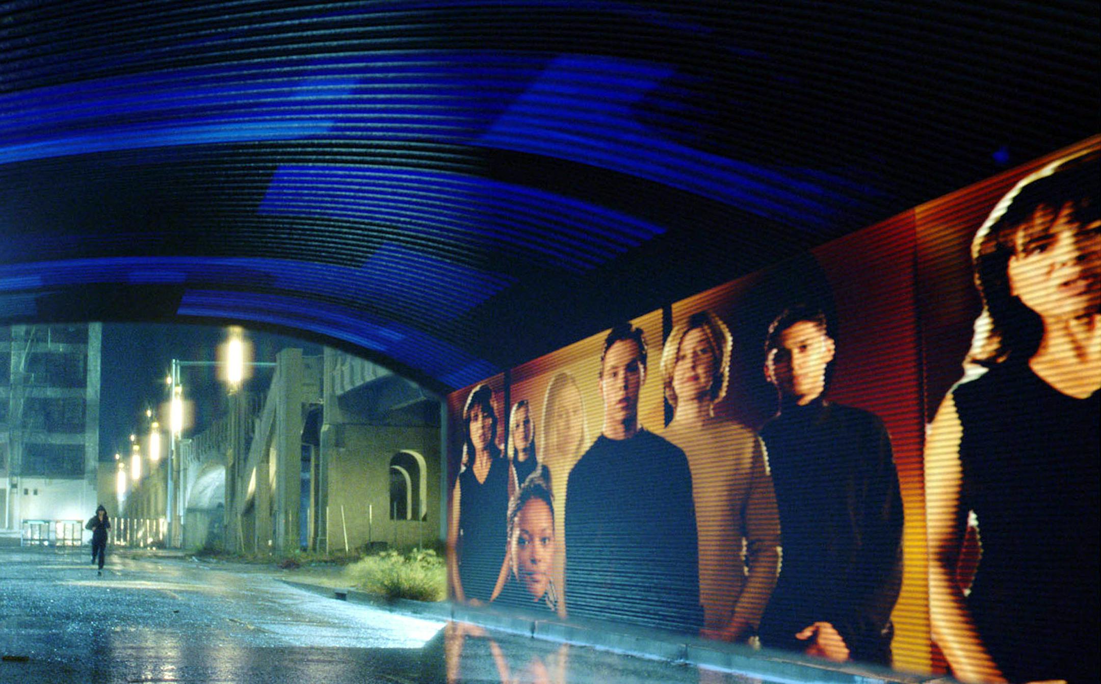 ** FOR RELEASE ANYTIME ** In this undated handout photo from Twentieth Century Fox, Tom Cruise runs a gantlet of electronic billboards that scan his retinas and hurl personalized pitches his way in a scene from Steven Spielberg's new movie "Minority Report." Many of the film's futuristic visions, including a holographic greeter at the Gap and animated cereal boxes, could become real using technology being developed today. (AP Photo/Twentieth Century Fox, David James)