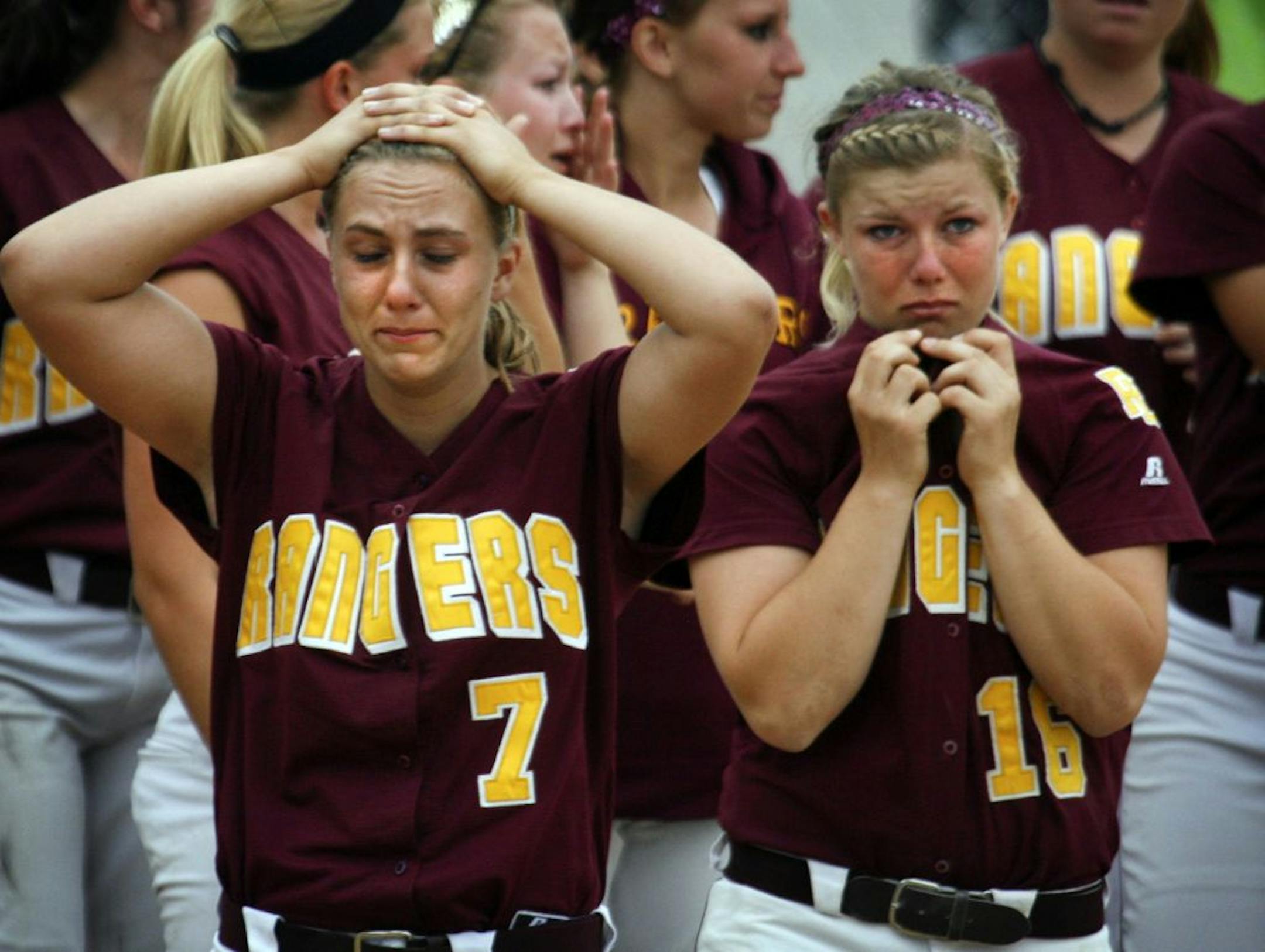 The pain of their 4-0 loss to Hastings last weekend at state was etched on the faces of starting pitcher Taylor Burmeister, left, and Kailey Hanson, her longtime catcher.
