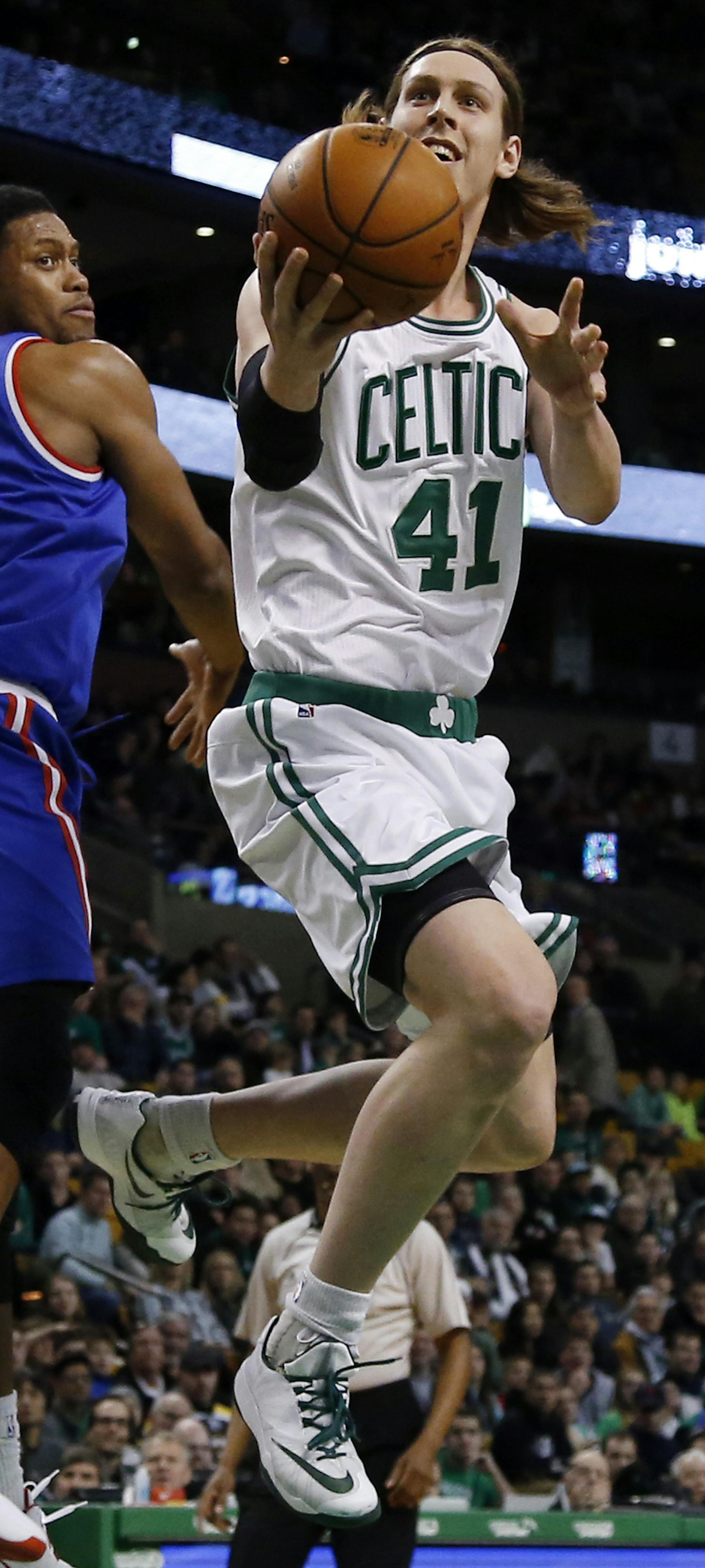 Boston Celtics center Kelly Olynyk (41) makes a move to the hoop past Sacramento Kings forward Rudy Gay (8) in the first half of an NBA basketball game in Boston, Wednesday, Dec. 31, 2014. (AP Photo/Elise Amendola) ORG XMIT: MAEA103