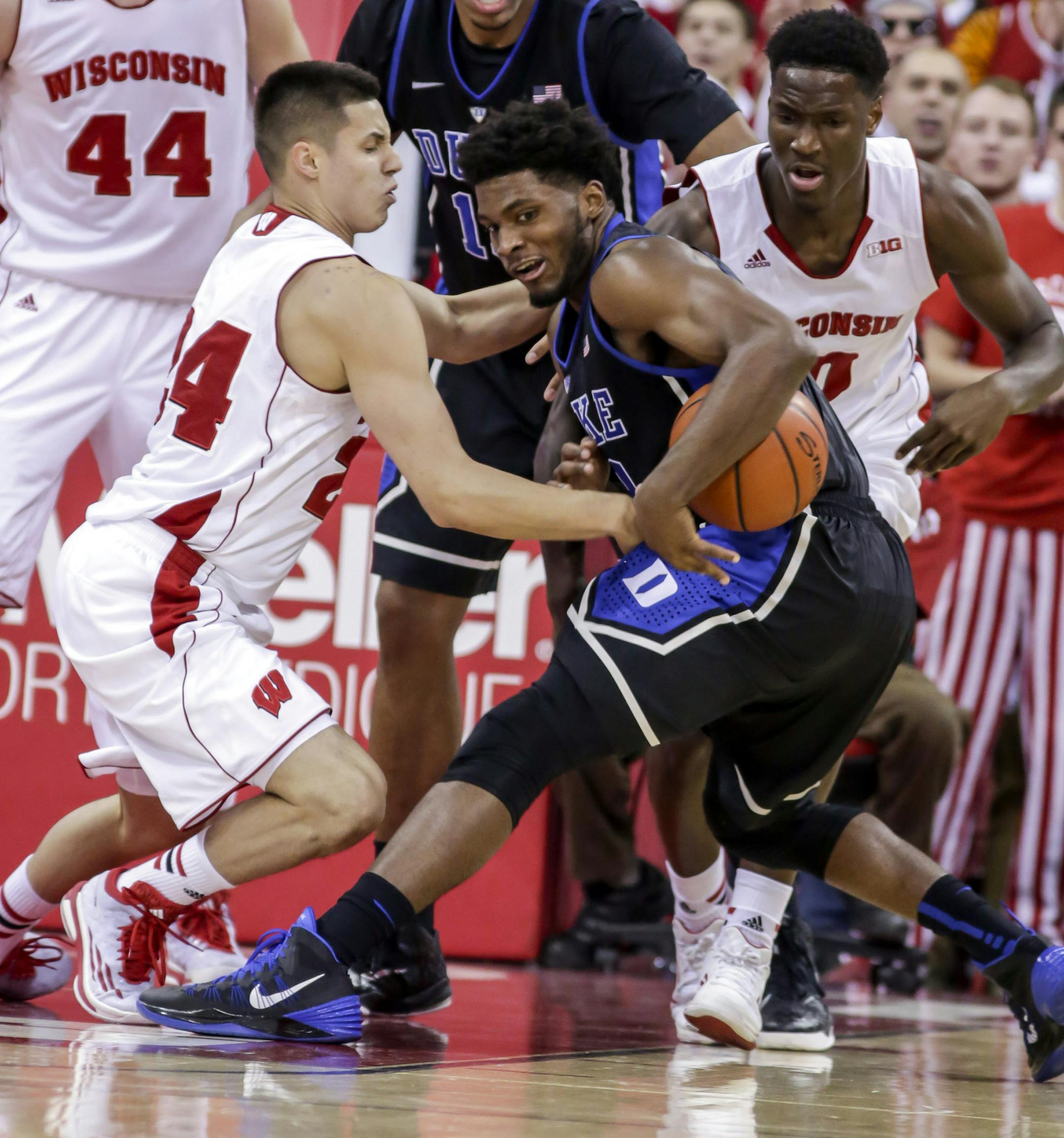Duke's Justise Winslow, right, gets a loose ball away from Wisconsin's Bronson Koenig during the second half of an NCAA college basketball game Wednesday, Dec. 3, 2014, in Madison, Wis. Duke won 80-70. (AP Photo/Andy Manis)