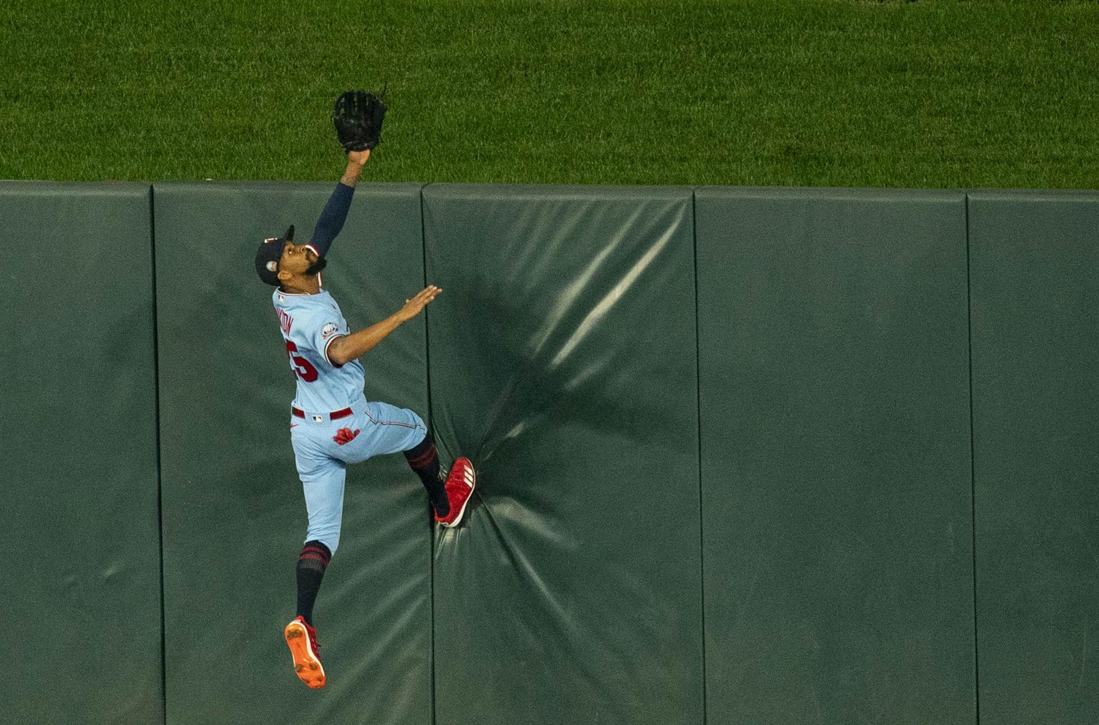 Minnesota Twins center fielder Byron Buxton (25) climbed the wall in a vain effort to save a home run in the fifth inning.