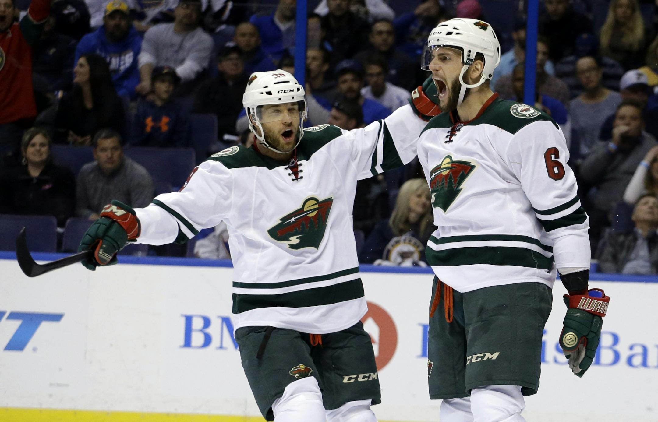 Minnesota Wild's Marco Scandella, right, is congratulated by teammate Jason Pominville after scoring during the first period in Game 5 of an NHL hockey first-round playoff series against the St. Louis Blues, Friday, April 24, 2015, in St. Louis.