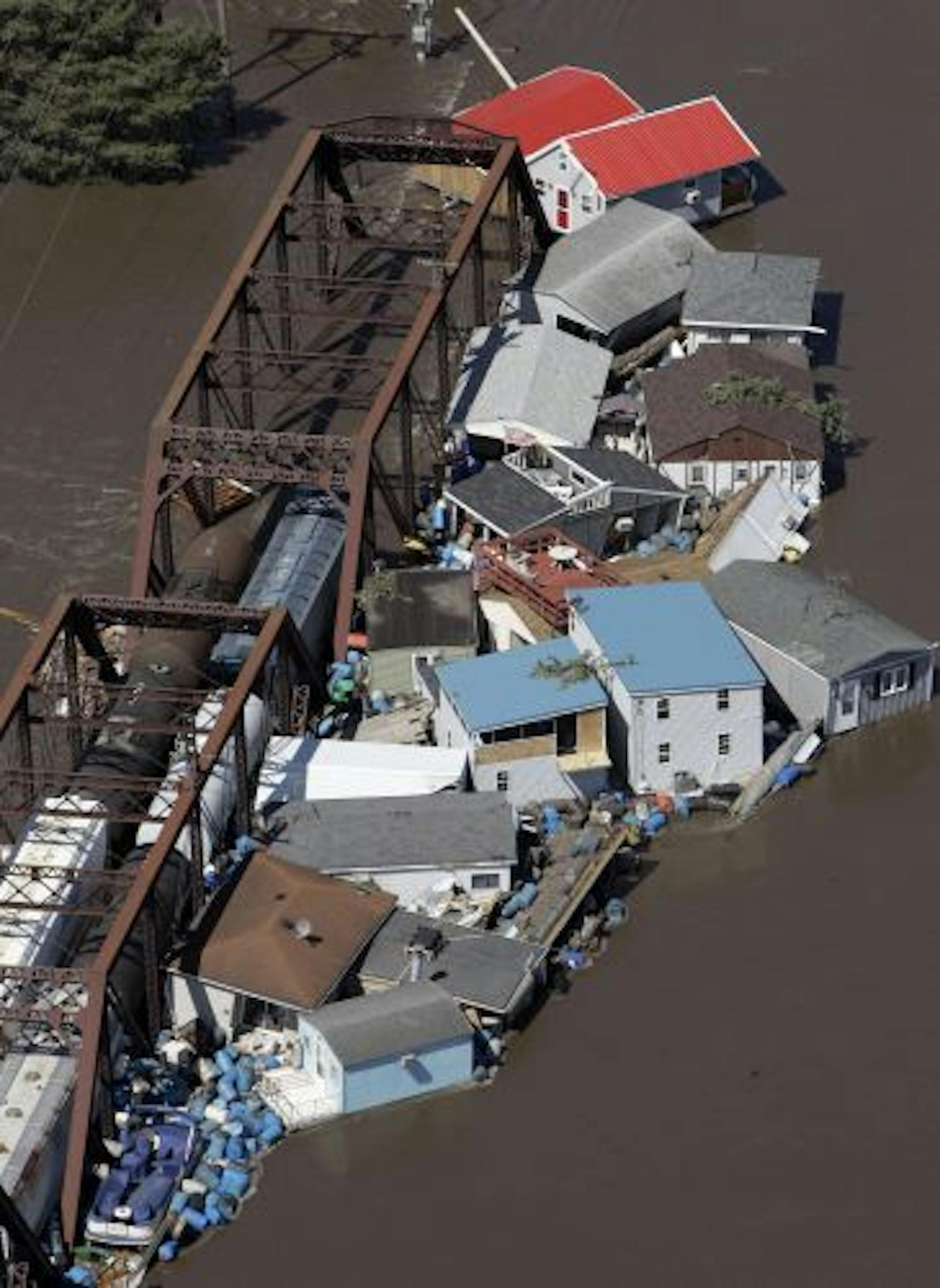 Buildings and debris are seen floating in the Cedar River against a railroad bridge on June 14, 2008, in Cedar Rapids, Iowa. Days after it rose out of its banks on its way to record flooding.