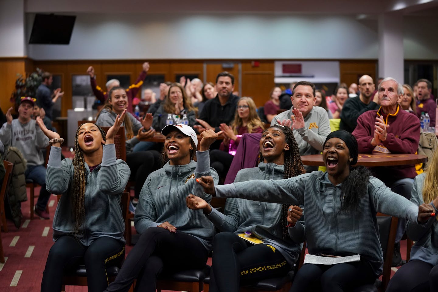 Gophers volleyball players (front, from left) Alexis Hart, Taylor Morgan, Stephanie Samedy and Adanna Rollins reacted to the news Sunday of being named the No. 7 seed in the NCAA tournament. The Gophers will open play against Fairfield at Maturi Pavilion on Friday.