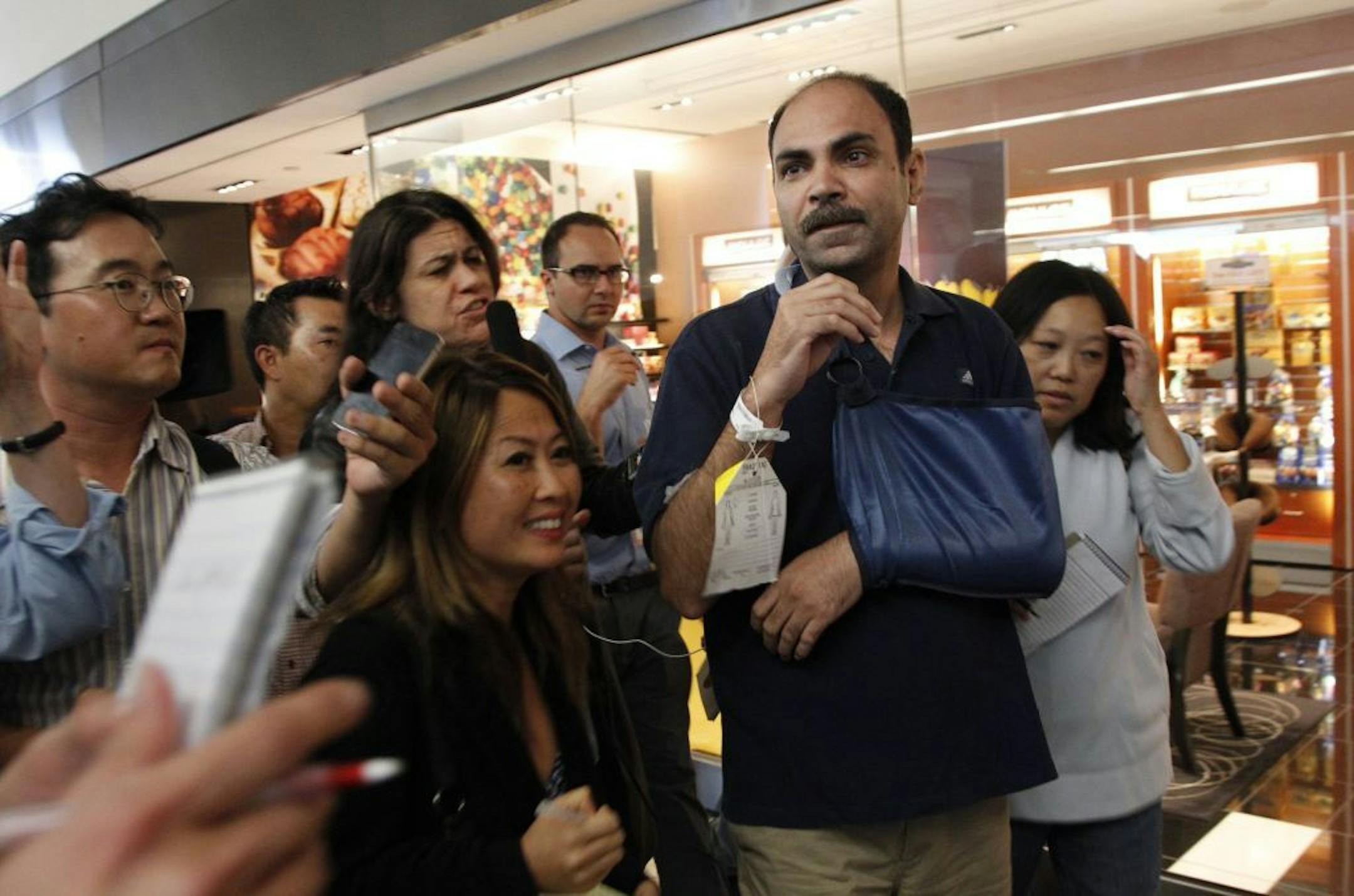 Passenger Veddpal Singh talks to reporters after an Asiana Airlines Boeing 777 arriving from Seoul, South Korea, crashed at the San Francisco International Airport, in San Francisco, California, on Saturday July 6, 2013. Singh broke his collarbone in the crash and was looking for his wife when he spoke to reporters.