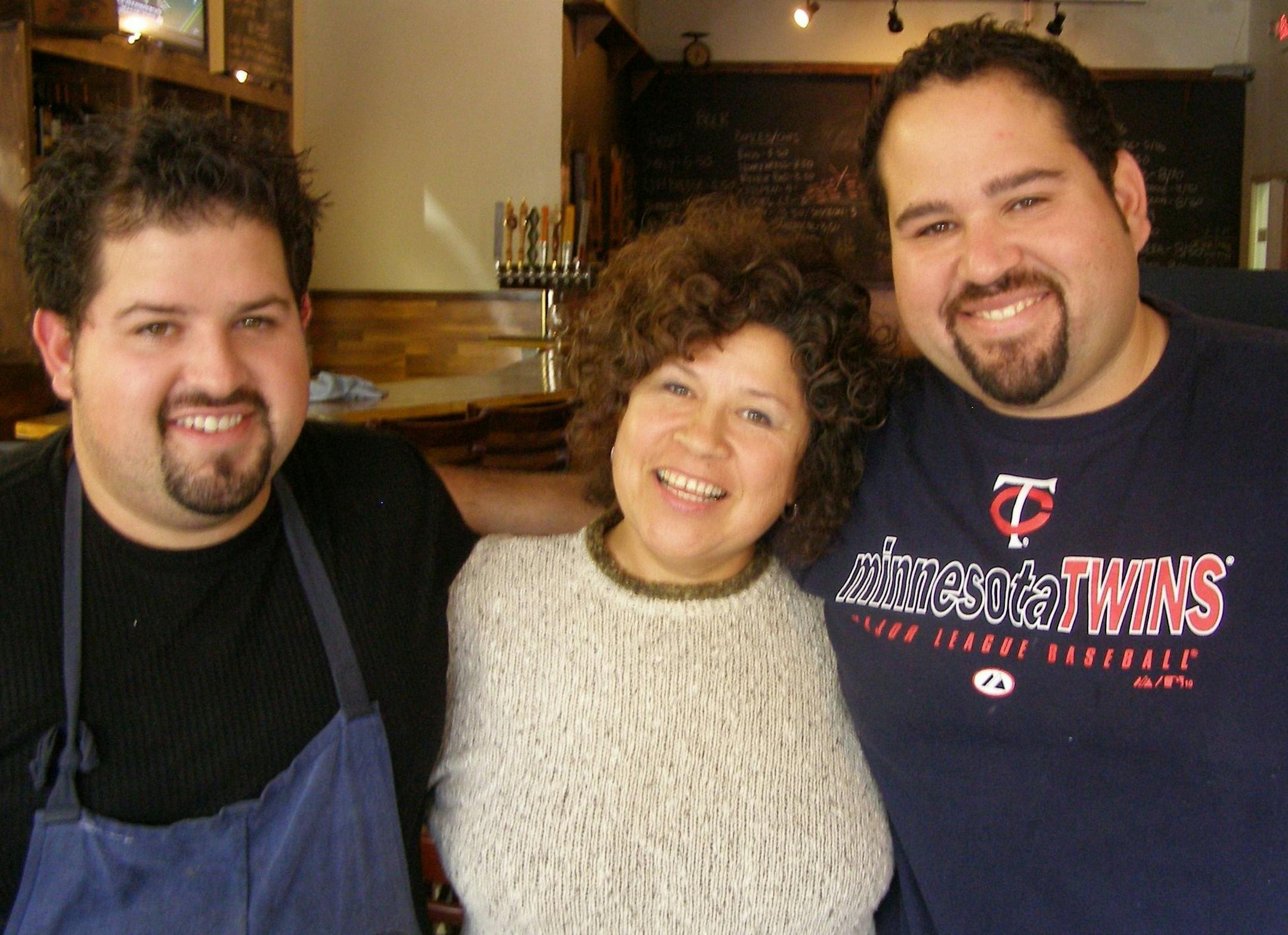 Mom Lupe hugs chef sons Mike Brown, left, and Matt Brown, right. Mike helped Matt cook after Matt's daughter got cancer.