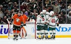 Wild players celebrated a goal by Joseph Cramarossa during Wednesday’s game in Anaheim.