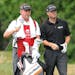 New Orleans Saints coach Sean Payton, left, caddied for Ryan Palmer during the pro-am for the Greenbrier Classic in White Sulphur Springs, W. Va., on 