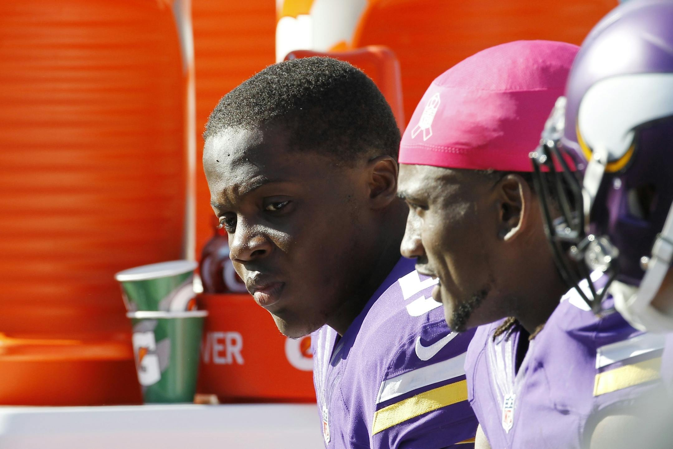 Minnesota Vikings quarterback Teddy Bridgewater, left, is seen on the sidelines during the second half of an NFL football game against the Detroit Lions, Sunday, Oct. 12, 2014, in Minneapolis. The Lions defeated the Vikings, 17-3. (AP Photo/Ann Heisenfelt)