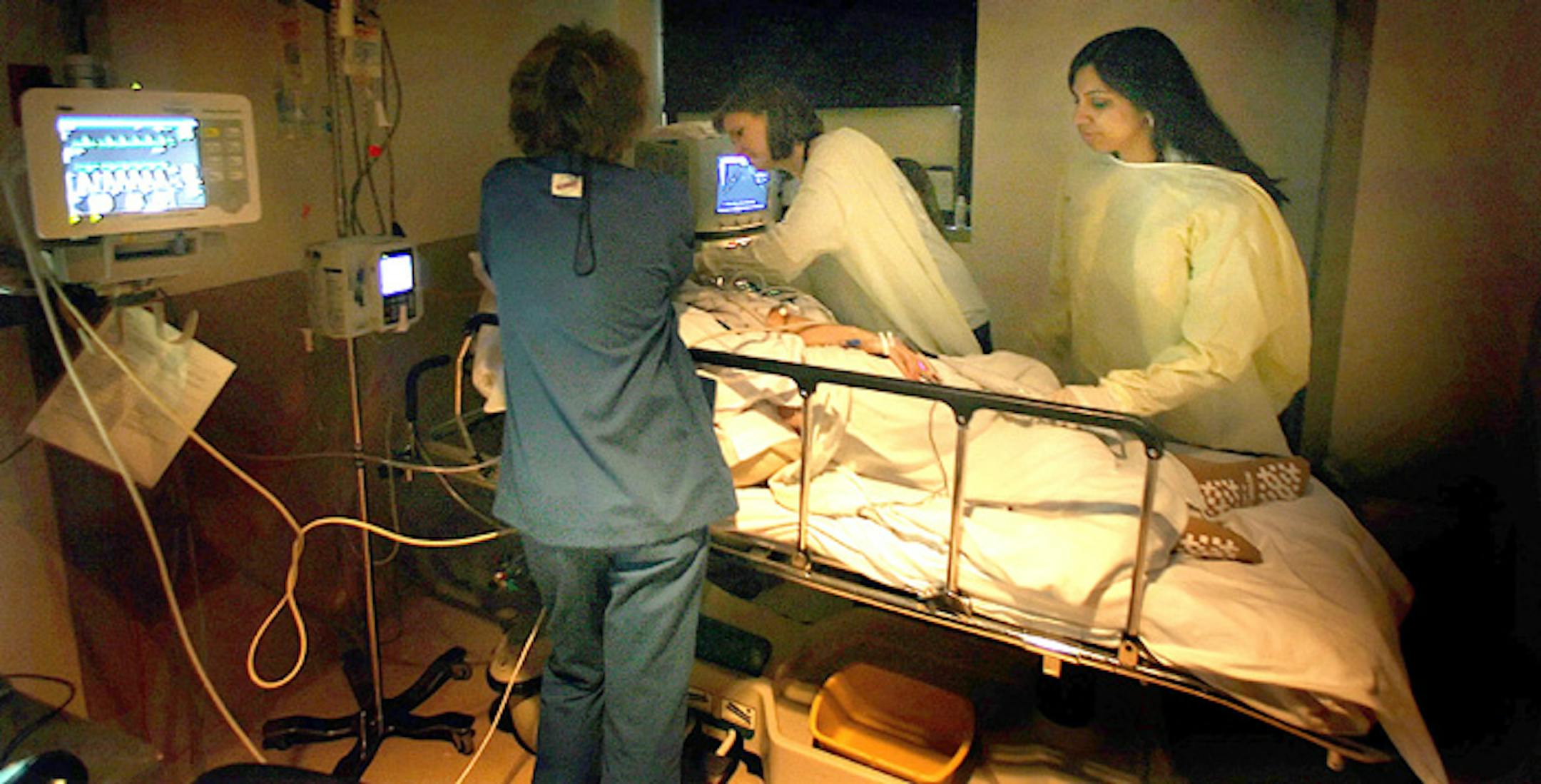 Dr. Shalini Bobra, right, prepared to examine a patient using echocardiography on Friday at Abbott Northwestern Hospital in Minneapolis. With her were Cynthia Brenden, center, a U of M cardiology fellow, and registered nurse Joan Curran.