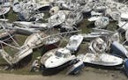 This Sept. 14, 2017 photo provided by Guillermo Houwer on Saturday, Sept. 16, shows some damaged boats at the Virgin Gorda Yacht Harbour in the afterm