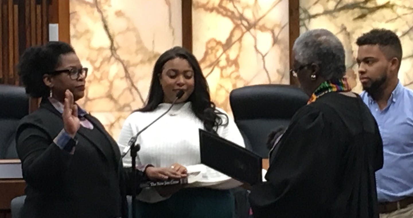 New commissioner Angela Conley being sworn in by retired District Court Judge Pamela Alexander.