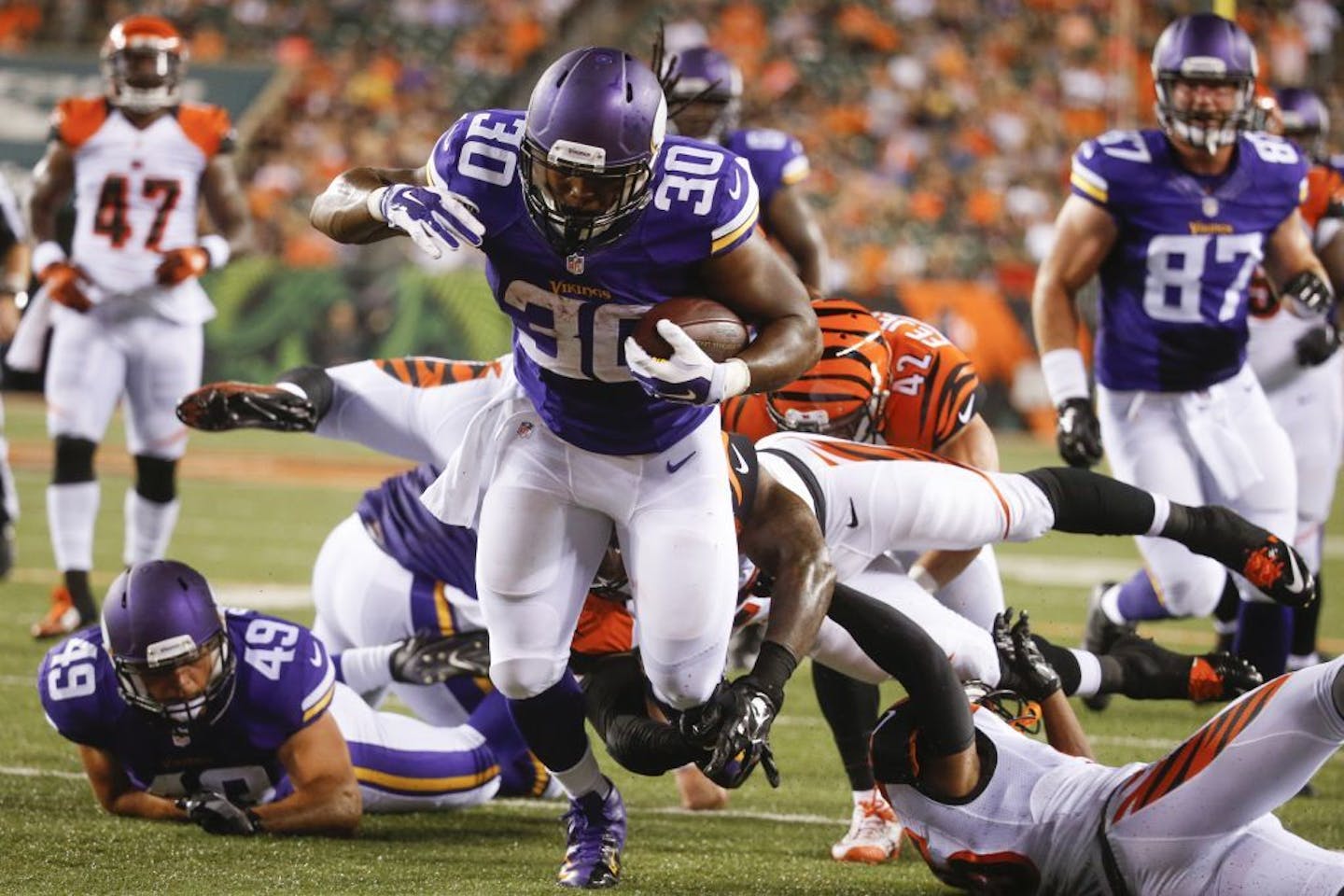 Minnesota Vikings running back C.J. Ham (30) runs through Cincinnati Bengals defensive back Floyd Raven (41), outside linebacker Darien Harris, right, and cornerback Corey Tindal, below, for a touchdown in the second half of an NFL preseason football game, Friday, Aug. 12, 2016, in Cincinnati.