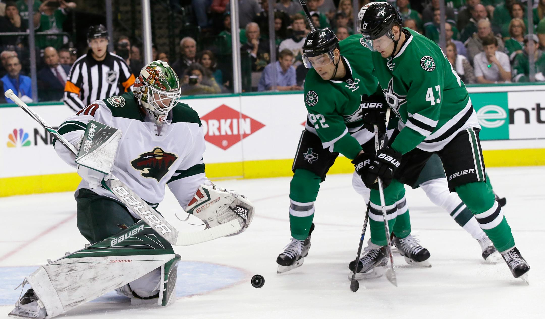 Minnesota Wild goalie Devan Dubnyk looks to gather up the puck next to Dallas Stars attackers Colton Sceviour (22) and Valeri Nichushkin (43) during the first period Thursday.