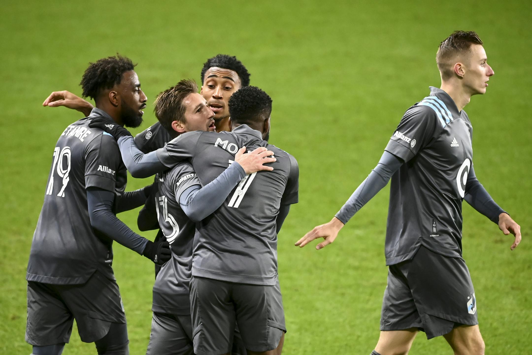 Teammates, including Minnesota United defender Romain Metanire (19) and midfielder Kevin Molino (7), celebrated with midfielder Ethan Finlay (13), second from left, after his late second half shot led to an own goal committed by Colorado on Wednesday night.