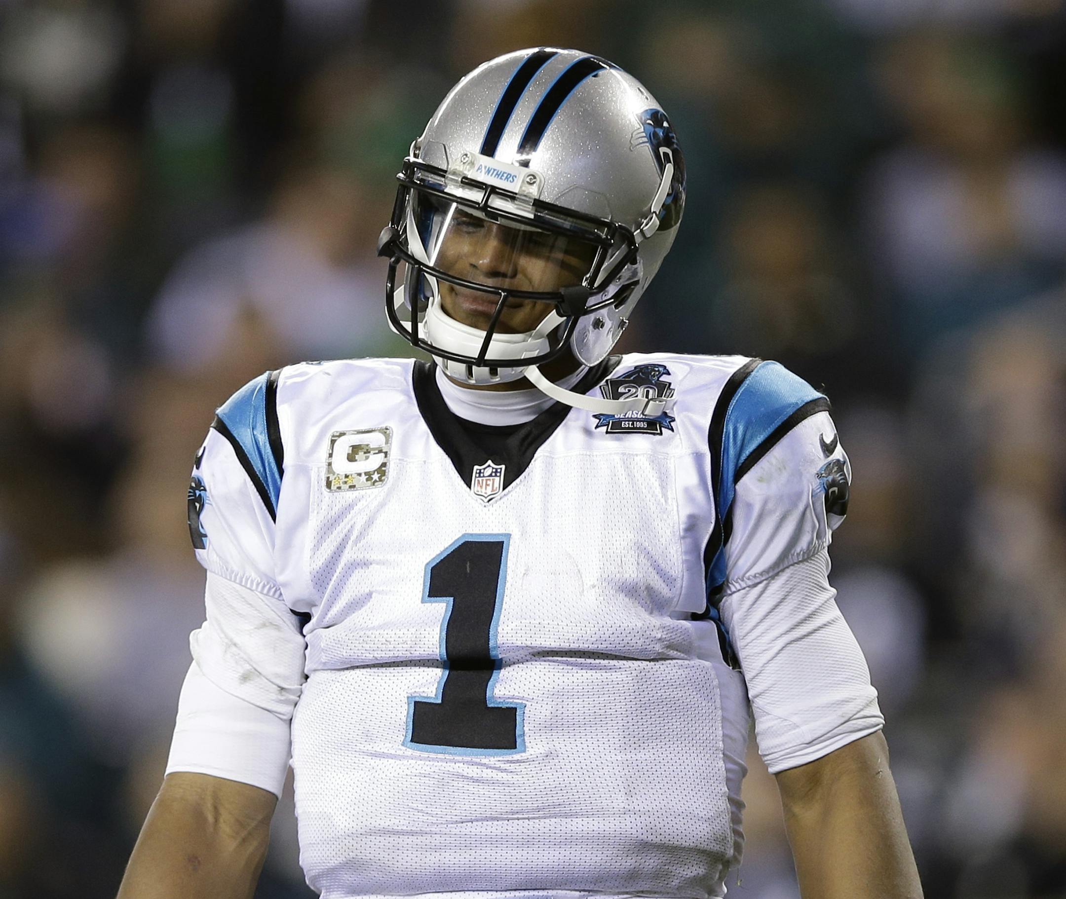 Carolina Panthers' Cam Newton reacts after being sacked during the second half of an NFL football game against the Philadelphia Eagles, Monday, Nov. 10, 2014, in Philadelphia. (AP Photo/Michael Perez) ORG XMIT: PXE121